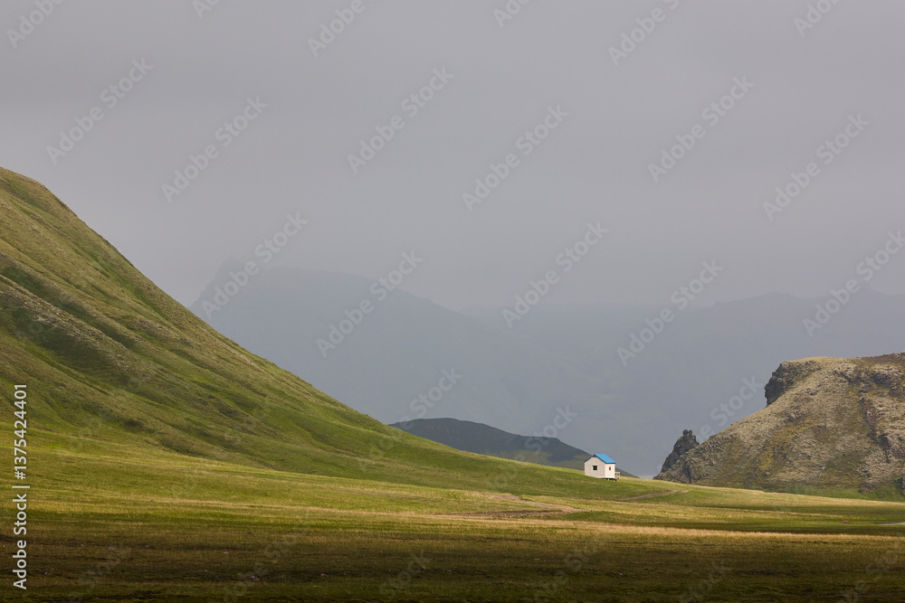 Picturesque shelter in a green misty landscape. Icelandic loneliness scenery