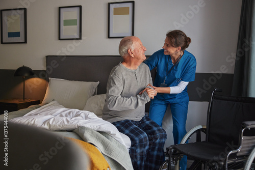 Wallpaper Mural Smiling nurse assisting disabled senior man to get up from bed Torontodigital.ca