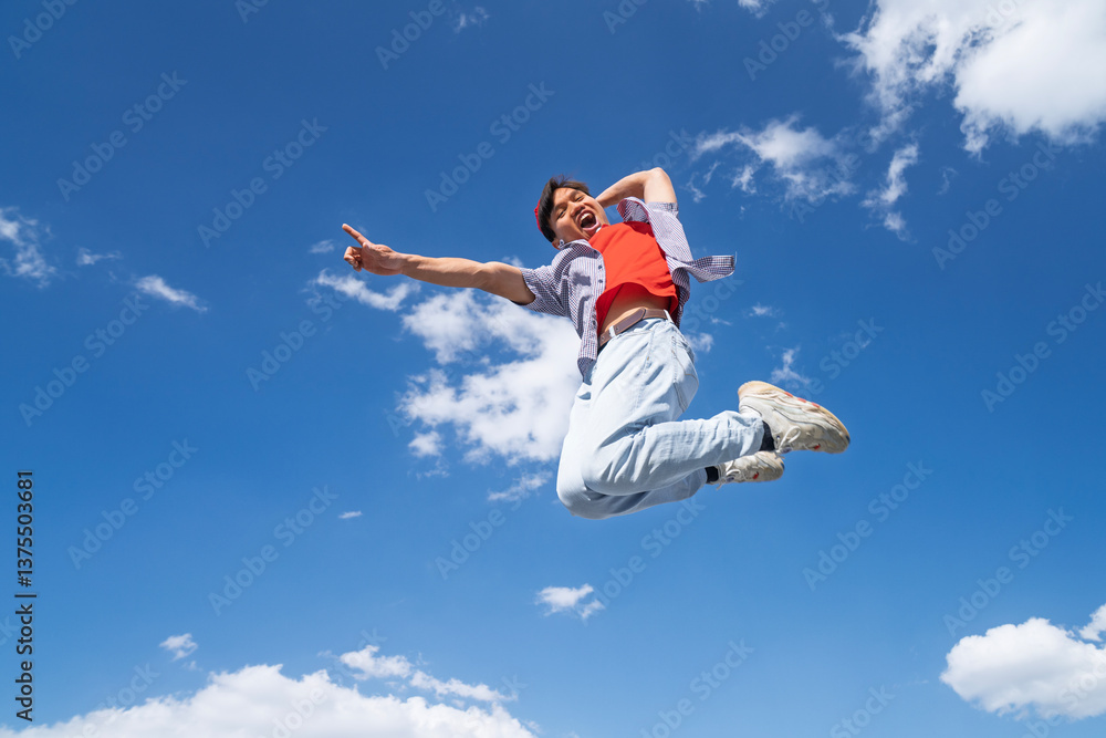 A man is jumping in the air with his arms outstretched. The sky is blue and there are clouds in the background. Scene is joyful and energetic A man is jumping in the air with his arms outstretched. The sky is blue and there are clouds in the background. Scene is joyful and energetic
