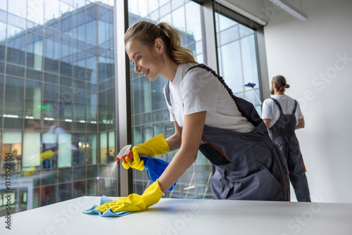 Group of young doing cleaning works in the office