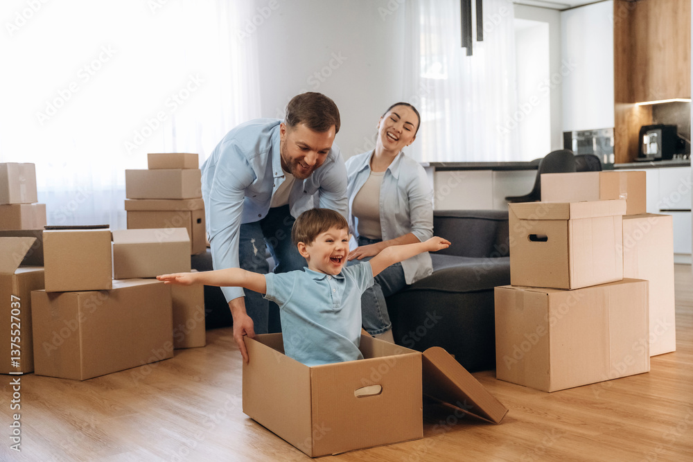 Imagination, flying, sitting in box. Family of husband, wife and son are moving into new house Imagination, flying, sitting in box. Family of husband, wife and son are moving into new house