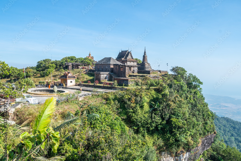 Naklejka premium An impressive building atop a lovely hill, surrounded by trees, Bokor National Park