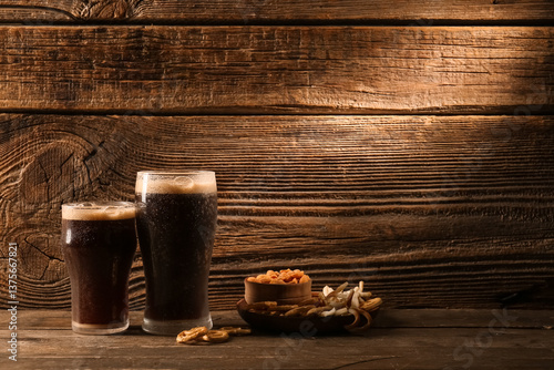 Glasses of dark beer and sn...