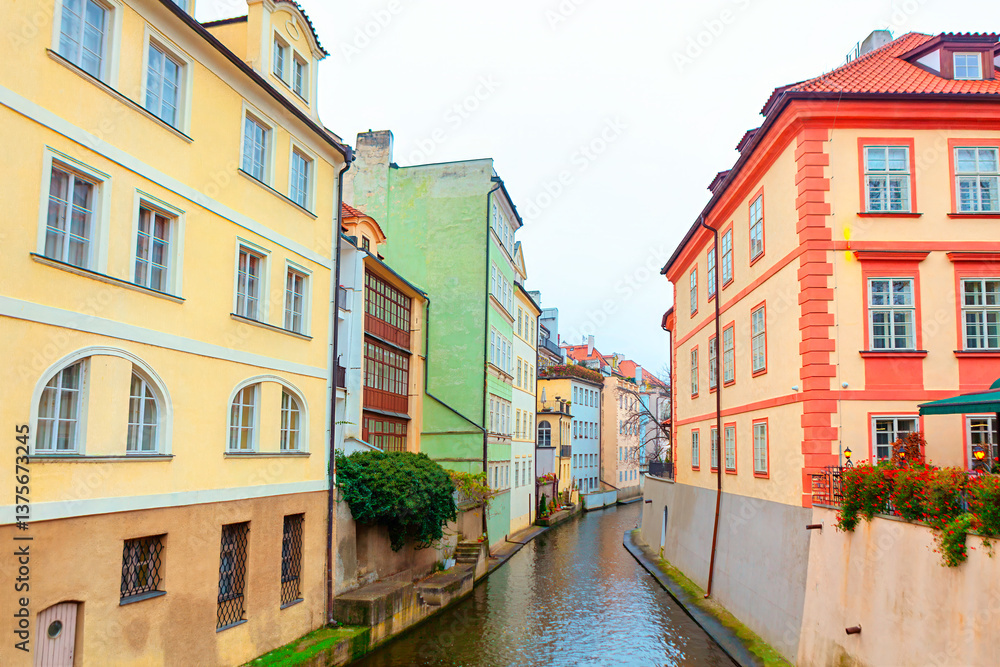 Certovka canal in Prague. Tranquil canal flows through downtown of Prague, bordered by colorful historic buildings that showcase city timeless charm and architectural beauty