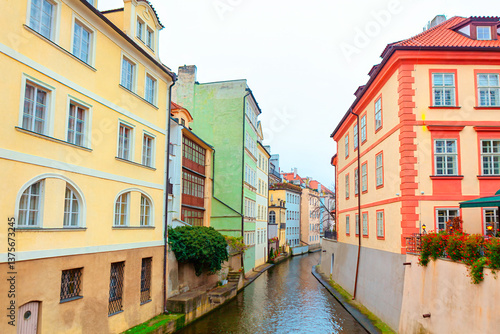 Obraz na płótnie Certovka canal in Prague. Tranquil canal flows through downtown of Prague, bordered by colorful historic buildings that showcase city timeless charm and architectural beauty w salonie