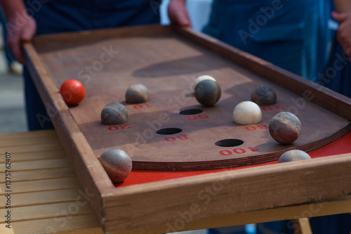 Wallpaper Mural An outdoor board game of Kulbuto played with friends. A competition to see how fast you can get balls into holes. Selective focus Torontodigital.ca