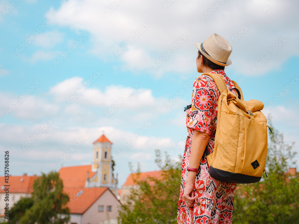 Obraz premium Beautiful woman walking of Varazdin streets during summer day in old, historical city center. Tourist exploring the beautiful streets, view on city from fortess