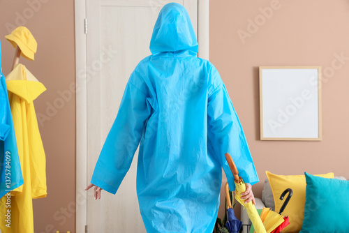 Woman with raincoat and umb...
