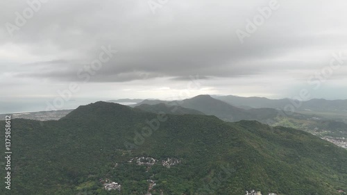 Exploring lush green mountains along the coastline on a cloudy day