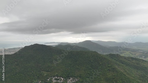 Beautiful landscape view of green mountains and cloudy skies by the coastal area