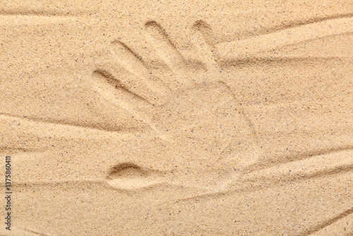 Handprint in golden beach s...