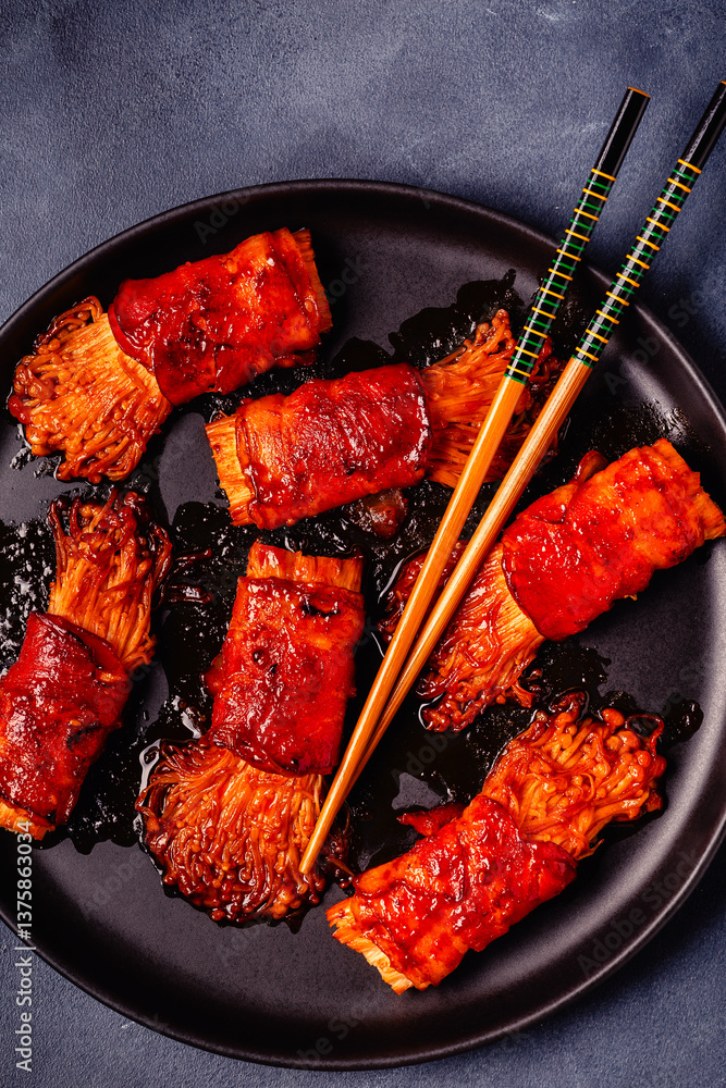 Bacon roll with enoki mushroom grilled with sauce.