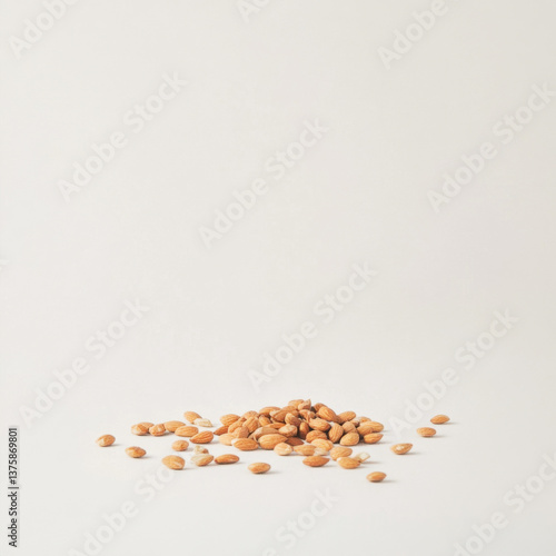 A clean, minimalistic image of a pile of almonds scattered on a pure white background, 