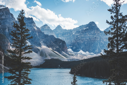 landscape and nature photograph shot during a summer journey in canada, with lakes, rocky mountains, animals and clouds through wide pine tree forests