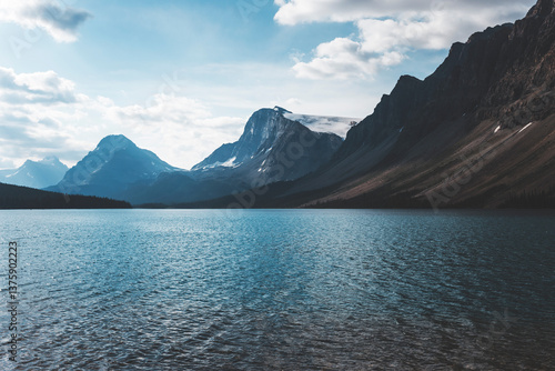 landscape and nature photograph shot during a summer journey in canada, with lakes, rocky mountains, animals and clouds through wide pine tree forests