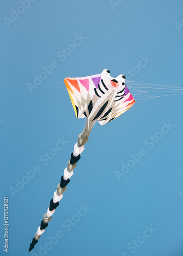 Colorful manta ray kite in blue sky