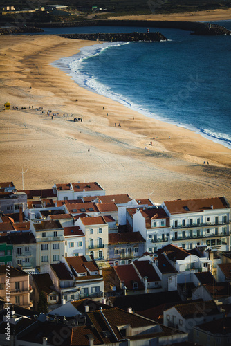 Obraz na płótnie A view of the coastal houses and the beach of Nazaré, Portugal, on a beautiful day. w salonie
