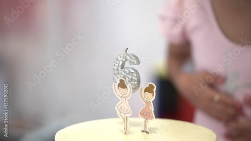 A charming moment of a 6th birthday celebration featuring a ballet-themed cake and candle, with a soft and joyful atmosphere perfect for kids' party or celebration content.