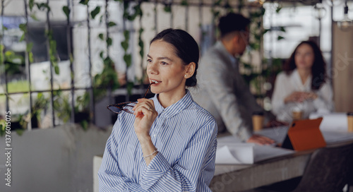 Принти на полотні A highly focused businesswoman takes a moment to reflect in her stylish, plantfi