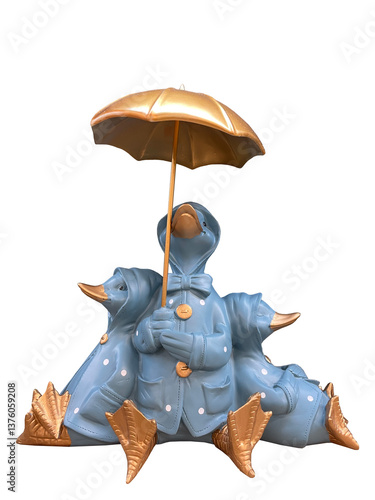 figurine three ducks under an umbrella