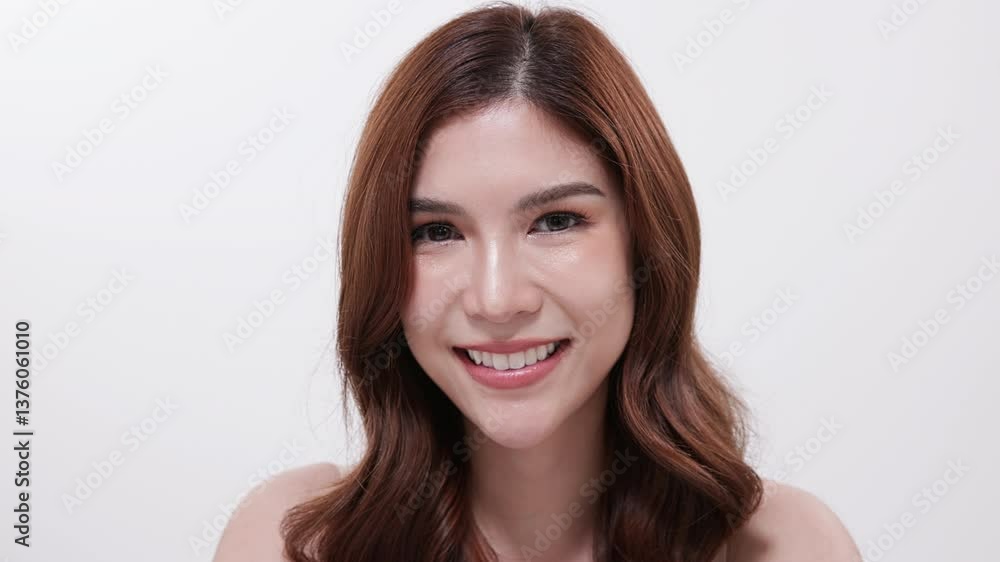 Smiling woman looking at skincare products on table Smiling woman looking at skincare products on table