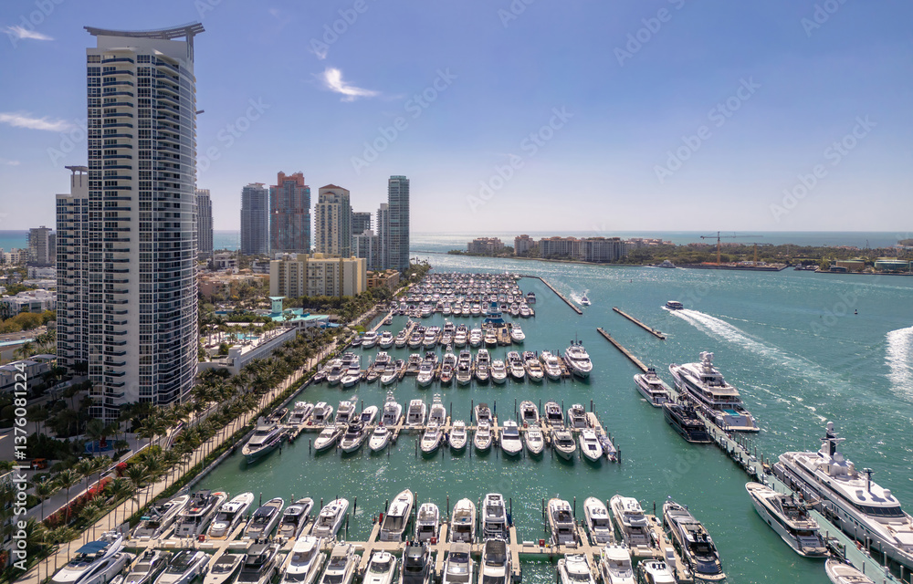 Luxury yacht cruising on Miamis coastline. Aerial view of yachts docked in Miami marina. Miami skyline yachts. Miami Beach with yacht in bay. Summer vacation in Miami. Yachts in South Pointe Marina.