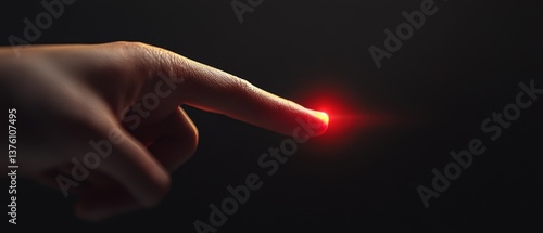 Obraz na płótnie A hand pointing to a red dot on a black background w salonie