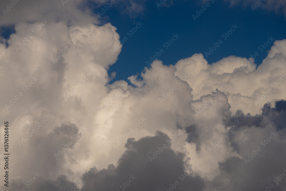 Obraz premium Background with cloudy skies. Cumulus clouds in sky. Blue cloudscape. Sky background. Cloudy sky with sunlight. White clouds background. Blue sky and white clouds background.