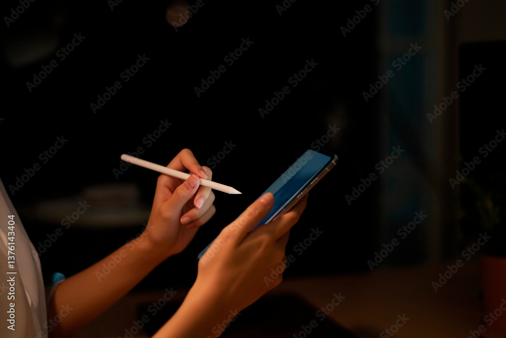 the hands of a woman holding a smartphone. In one hand she holds the phone, and in the other - a stylus or pen