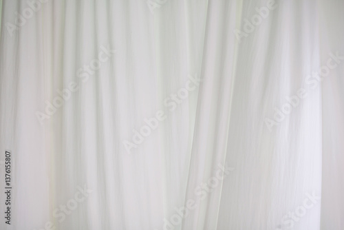 The white curtains are soft and wavy.