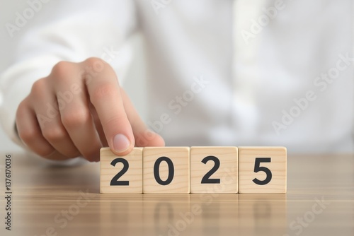 Hand turning wooden blocks with numbers to change 2024 to 2025 on a table, white background. Concept of new year, future, and transition. Ai generative
