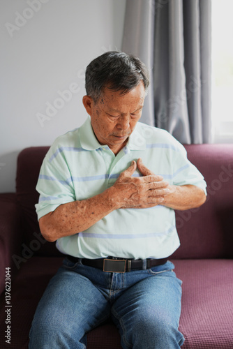 Senior asian adult elderly man with chest pain suffering from heart attack, health and medical, heart health, heart attack, world heart day, cardiovascular disease, insurance and hospital concept.