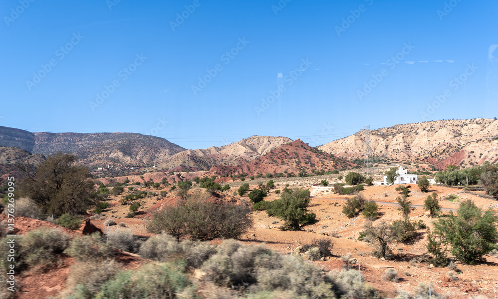 Naklejka premium Morocco semi-deserts and mountains, north africa nature, Moroccan stone desert, red hills, villages and argan trees