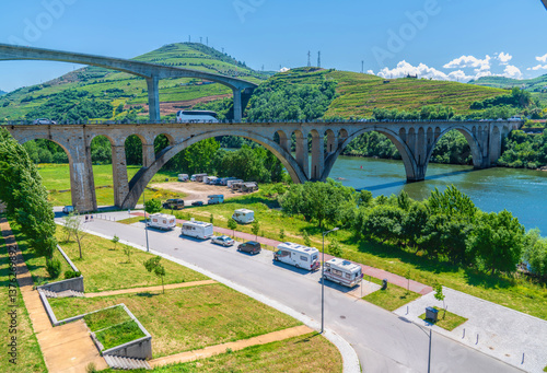 Motorhomes parked Douro River Peso da Regua Portugal near the two bridges tourist attraction