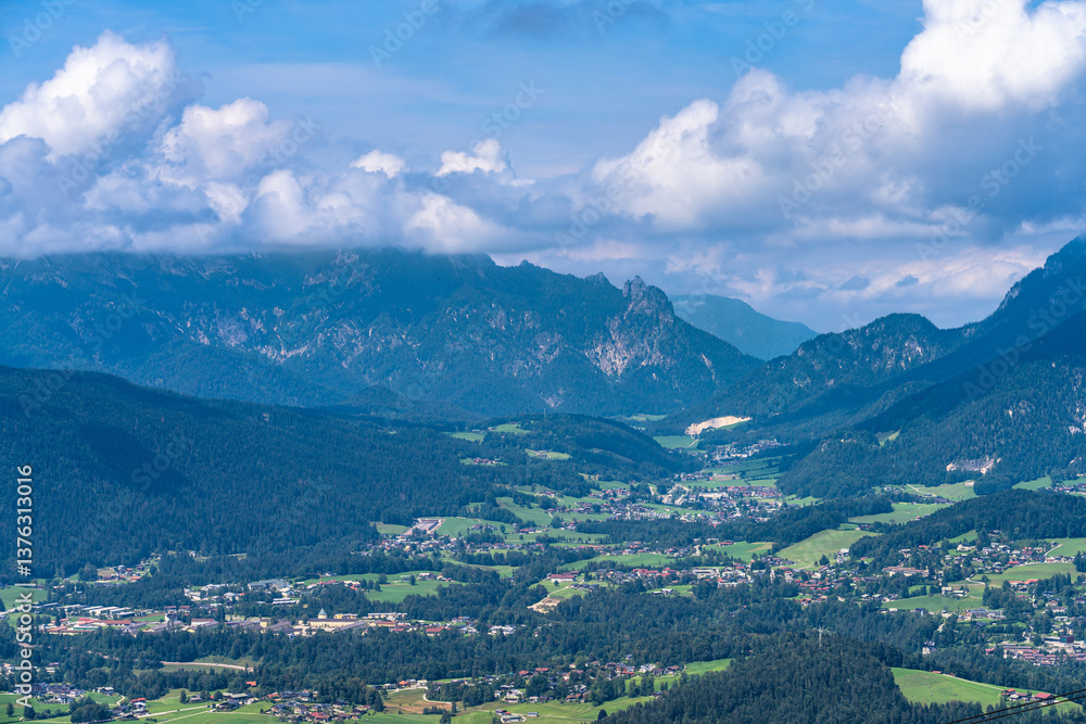 Fototapeta premium Panorama view of Schoenau town on the lake side of Koenigssee lake in Berchtesgaden national park from middle station of mountain Jenner on a sunny summer day with blue sky and cloud, Bavaria, Germany