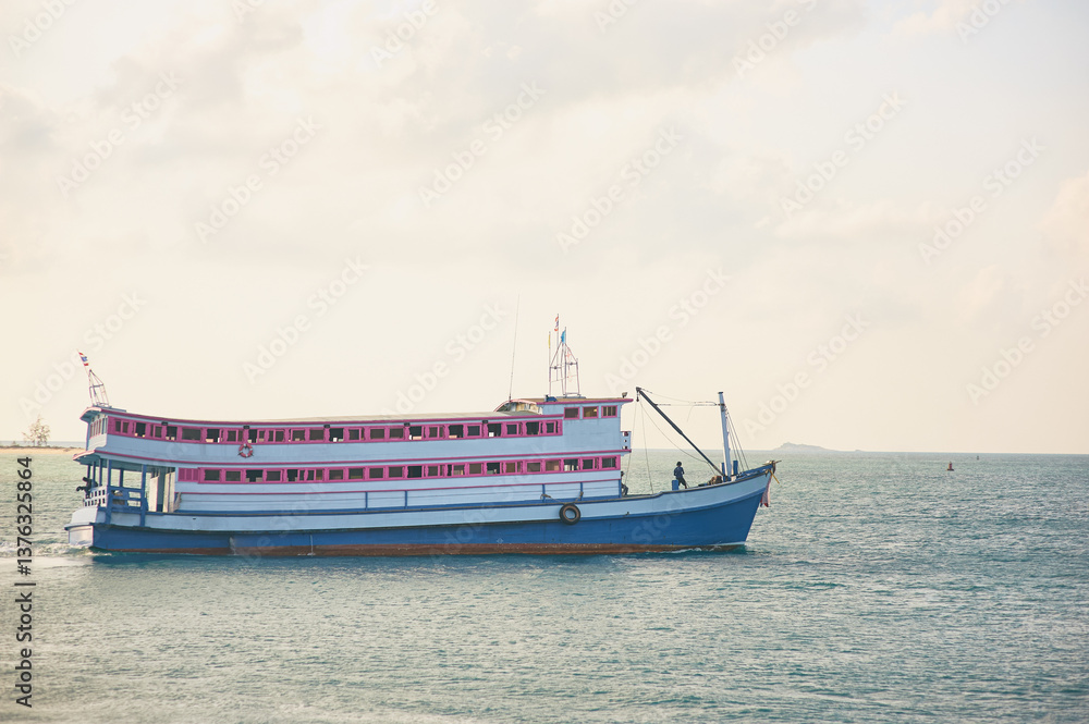 Scenic View of Thai Tour Boat on Tropical Ocean Water with Lush Hills Beyond Scenic View of Thai Tour Boat on Tropical Ocean Water with Lush Hills Beyond