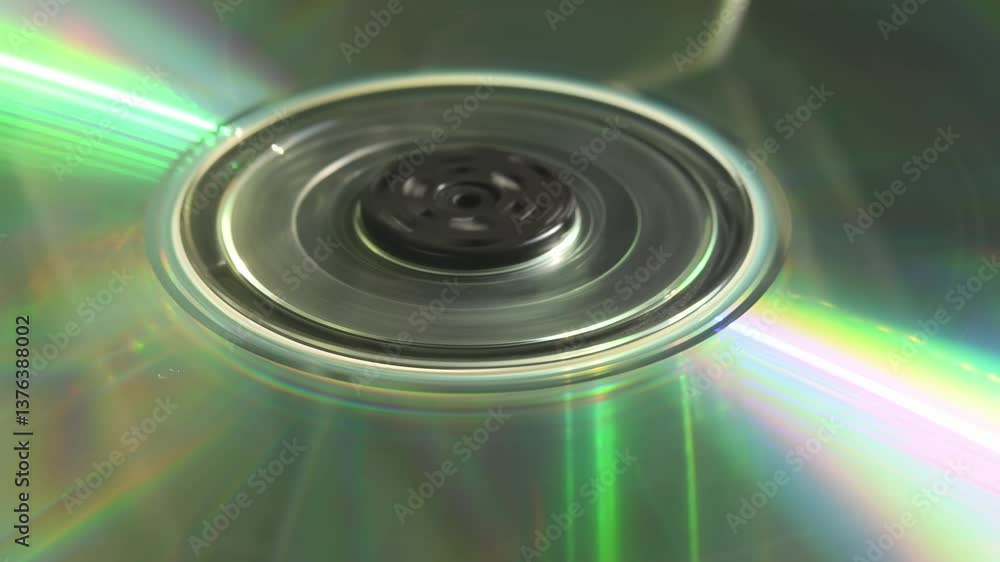 Double-sided CD stalls after short spin inside tray as person loads it, capturing fragile charm of 90s tech and imperfect media moments in 4K