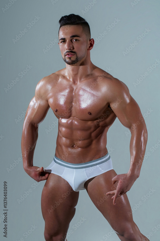 Fototapeta premium Man in underwear. Sexy guy in muscular naked body in sexy underwear. Seductive male model with muscles in underwear. Handsome young guy with perfect muscular body, torso posing in boxers underwear.