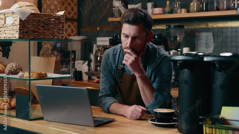 Pensive Caucasian entrepreneur barista employee male browsing Internet app laptop commerce small business owner thinking in cafeteria manager choosing guy online shopping cafe man waiter typing gadget Pensive Caucasian entrepreneur barista employee male browsing Internet app laptop commerce small business owner thinking in cafeteria manager choosing guy online shopping cafe man waiter typing gadget