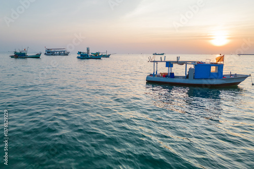 A Beautiful Serene Sunset Over the Calm Sea with Boats Sail Gently Across the Waters Surface, Phu Quoc, Vietnam
