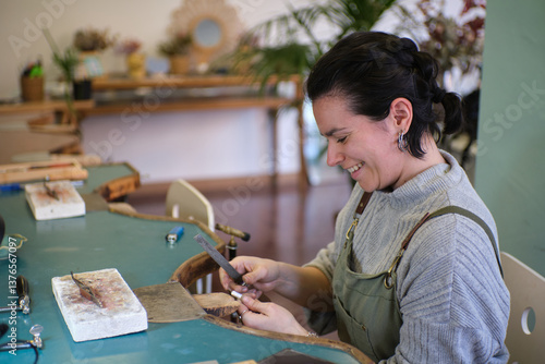 Photos Jeweler filing metal in workshop creating jewelry