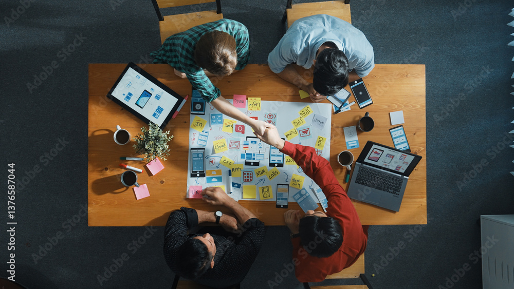 Fototapeta premium Professional developer team sharing idea of Ux Ui design by using mind map. Top down view of group of business people working together to brainstorm or plan mobile phone interface app. Convocation.