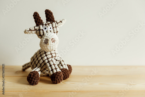 A cute stuffed giraffe, a stuffed toy on a light, simple background.