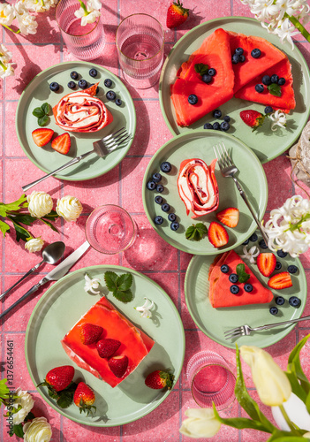 Delicious reddish pancakes and strawberry cake served on green plates for a fancy brunch