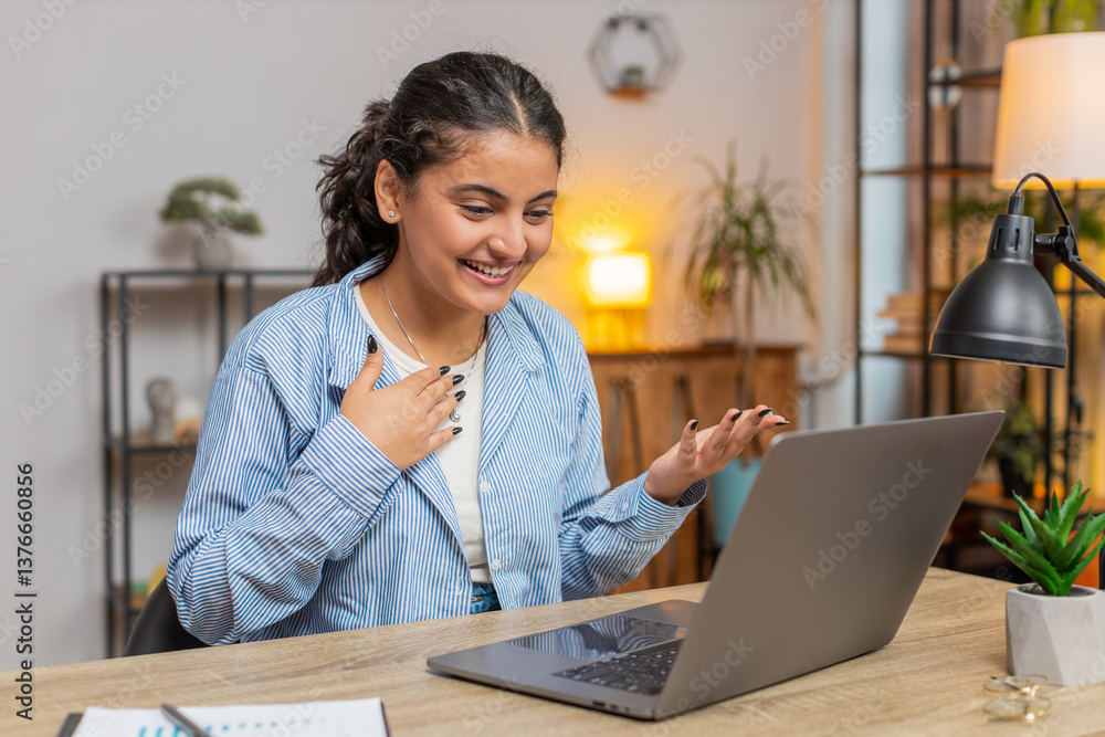 Happy woman freelancer working on laptop computer at home office desk talk on online communication video call with employee boss. Manager girl support services looking at webcam of computer. Lifestyle Happy woman freelancer working on laptop computer at home office desk talk on online communication video call with employee boss. Manager girl support services looking at webcam of computer. Lifestyle