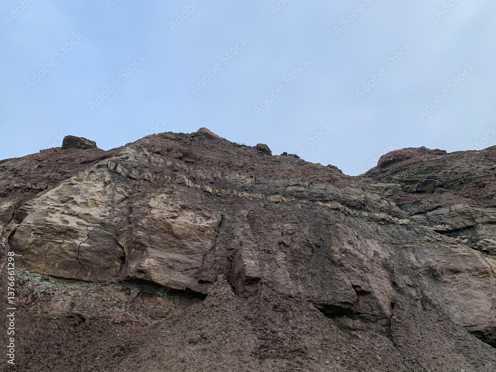 Majestic rocky cliff under clear sky, perfect for adventure travel, geology exploration, nature photography, mountain hiking inspiration Majestic rocky cliff under clear sky, perfect for adventure travel, geology exploration, nature photography, mountain hiking inspiration
