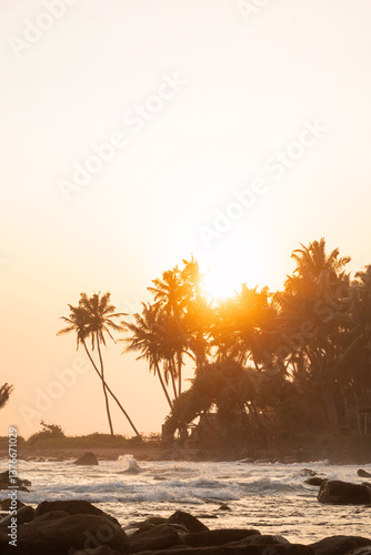 Obraz na płótnie Beautiful sunset on tropical island. Silhouette of palm trees at sunset. Panoramic beach landscape. Inspire tropical nature seascape horizon. Outdoors. World Ocean Day. w salonie