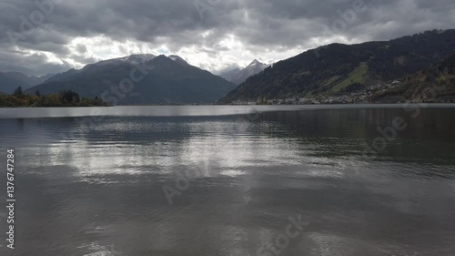Lake Zell in Pinzgau Austria at dusk in autumn, colorful foliage swaying in the wind