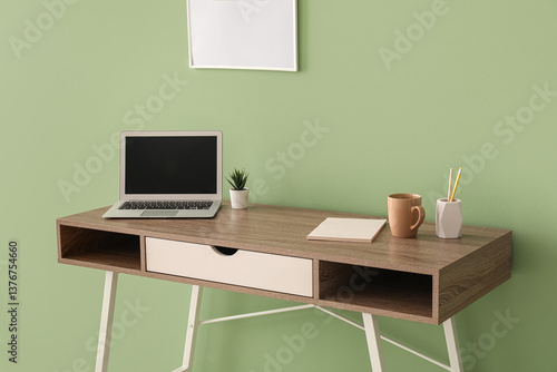 Workplace with laptop, hous...