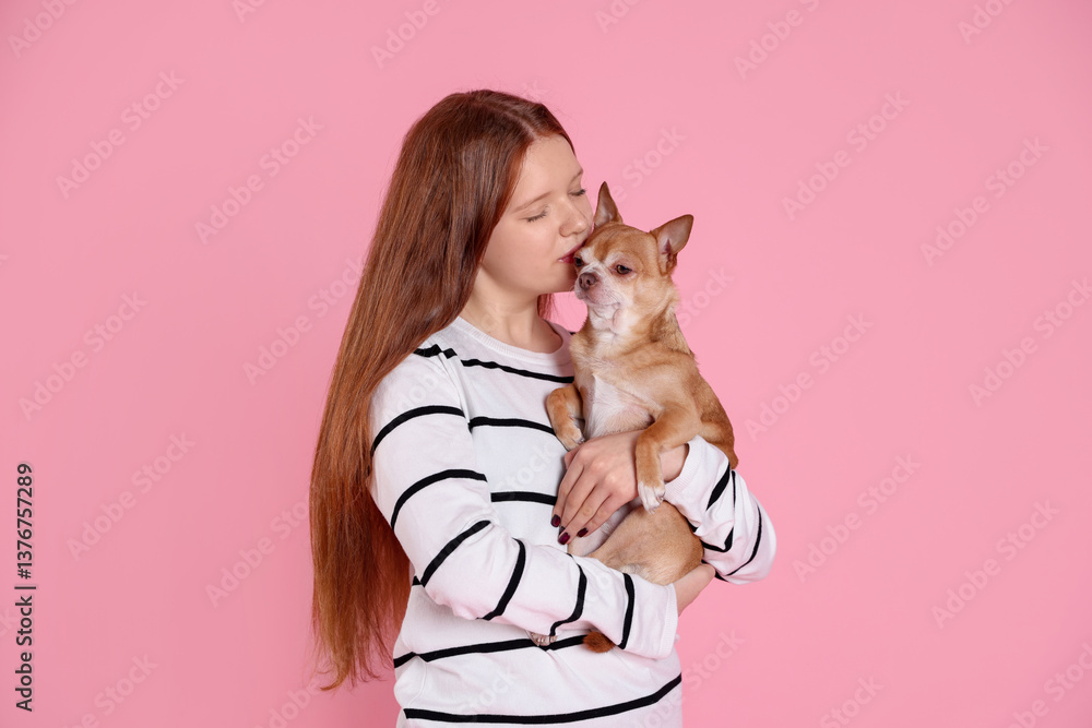 Obraz premium Teenage girl with her cute Chihuahua dog on pink background